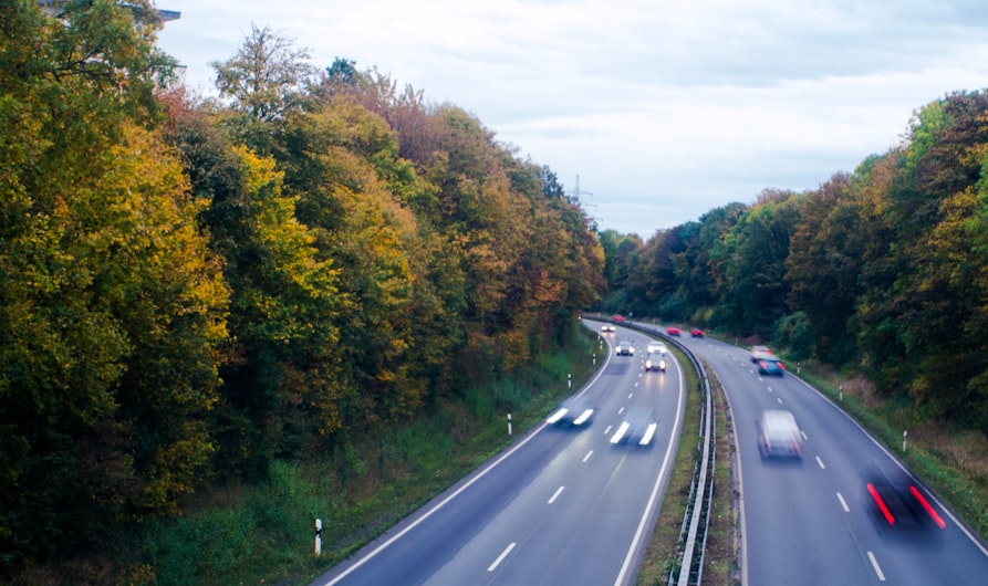 a highway with a bunch of cars driving down it