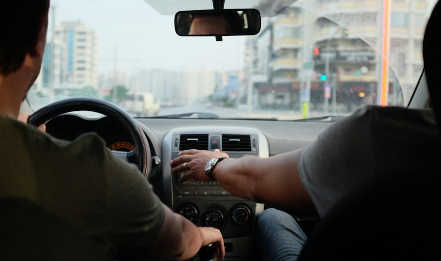 two person riding vehicle during daytime
